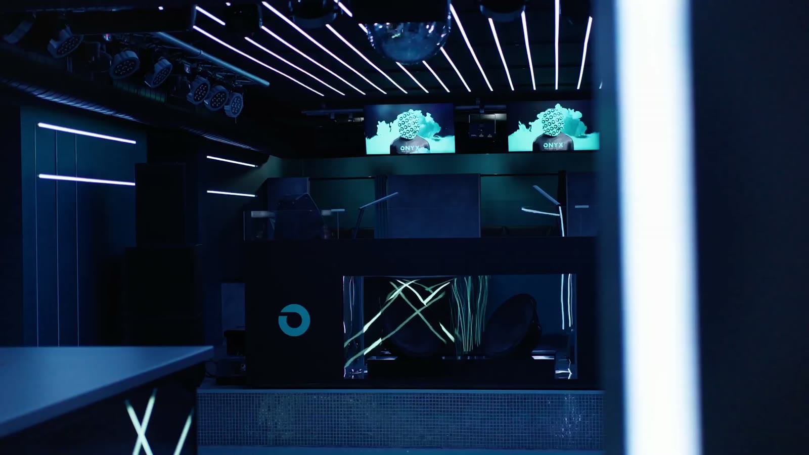 The same masked figure running on the venue screens above the DJ booth