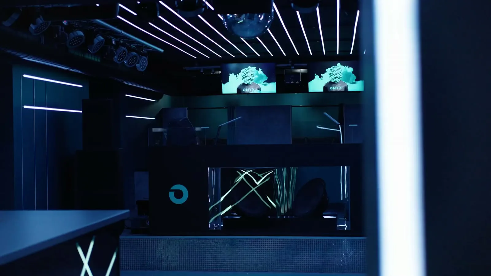 The same masked figure running on the venue screens above the DJ booth