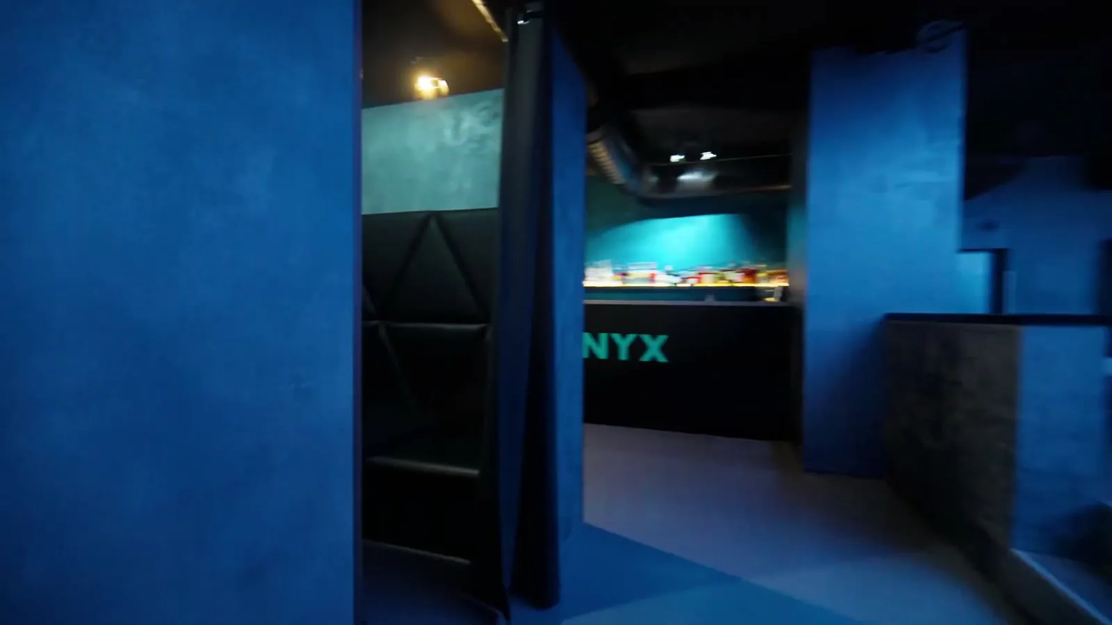 Blue corridor leading into the ONYX bar