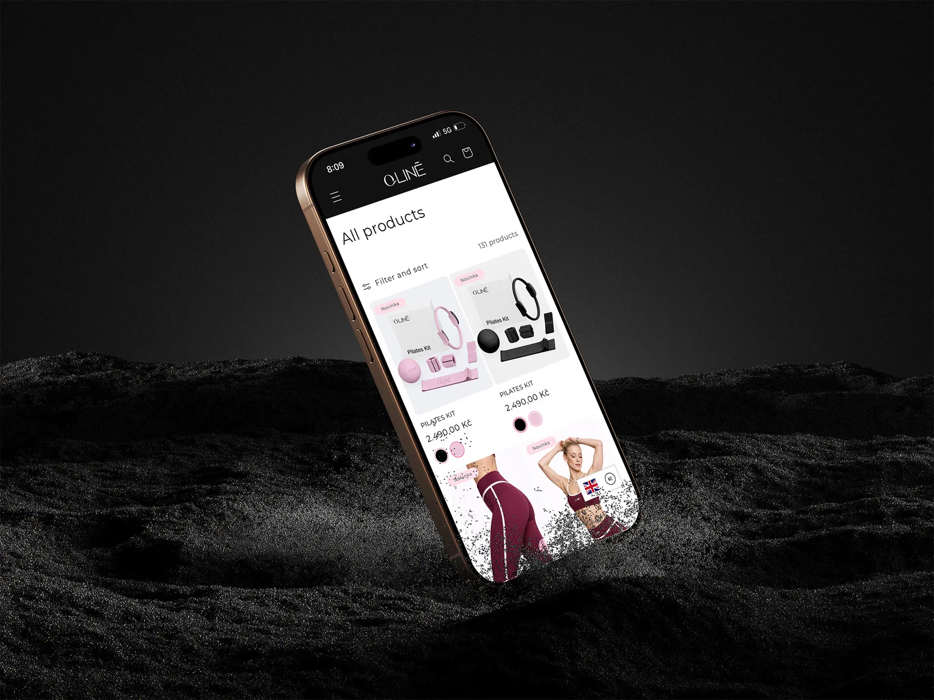 The QLINE mobile store on an iPhone rising out of black sand